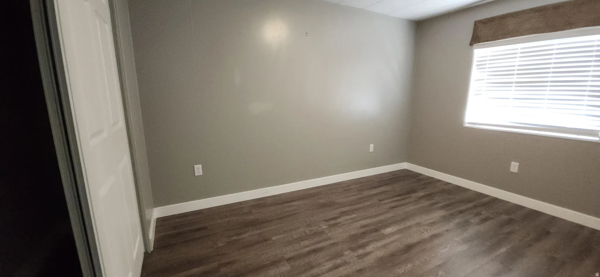 Neutral wall tones with wood-finish flooring