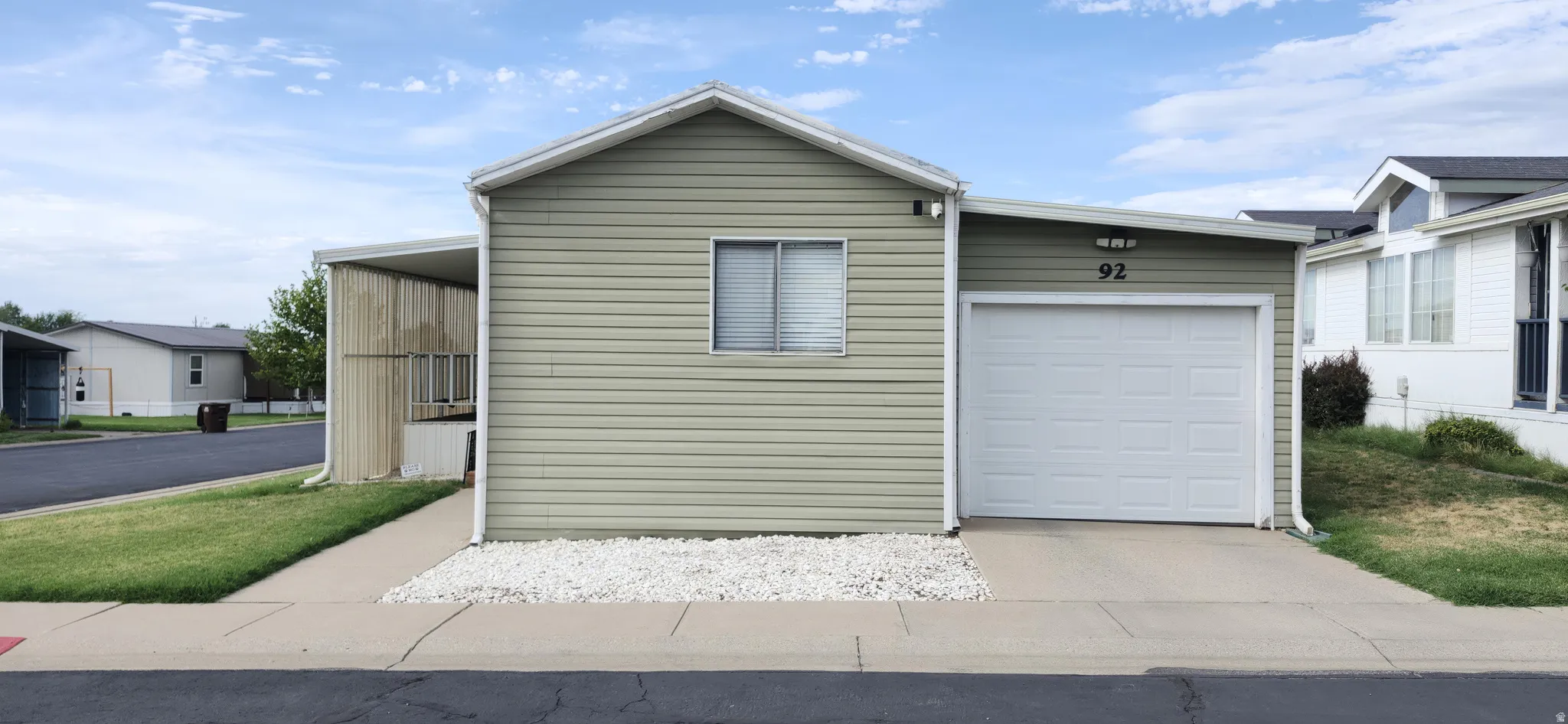Light green horizontal siding exterior with white trim