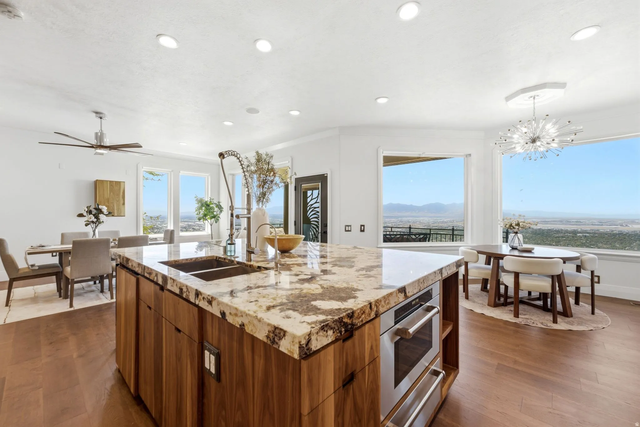Expansive kitchen island with a stone countertop and integrated sink