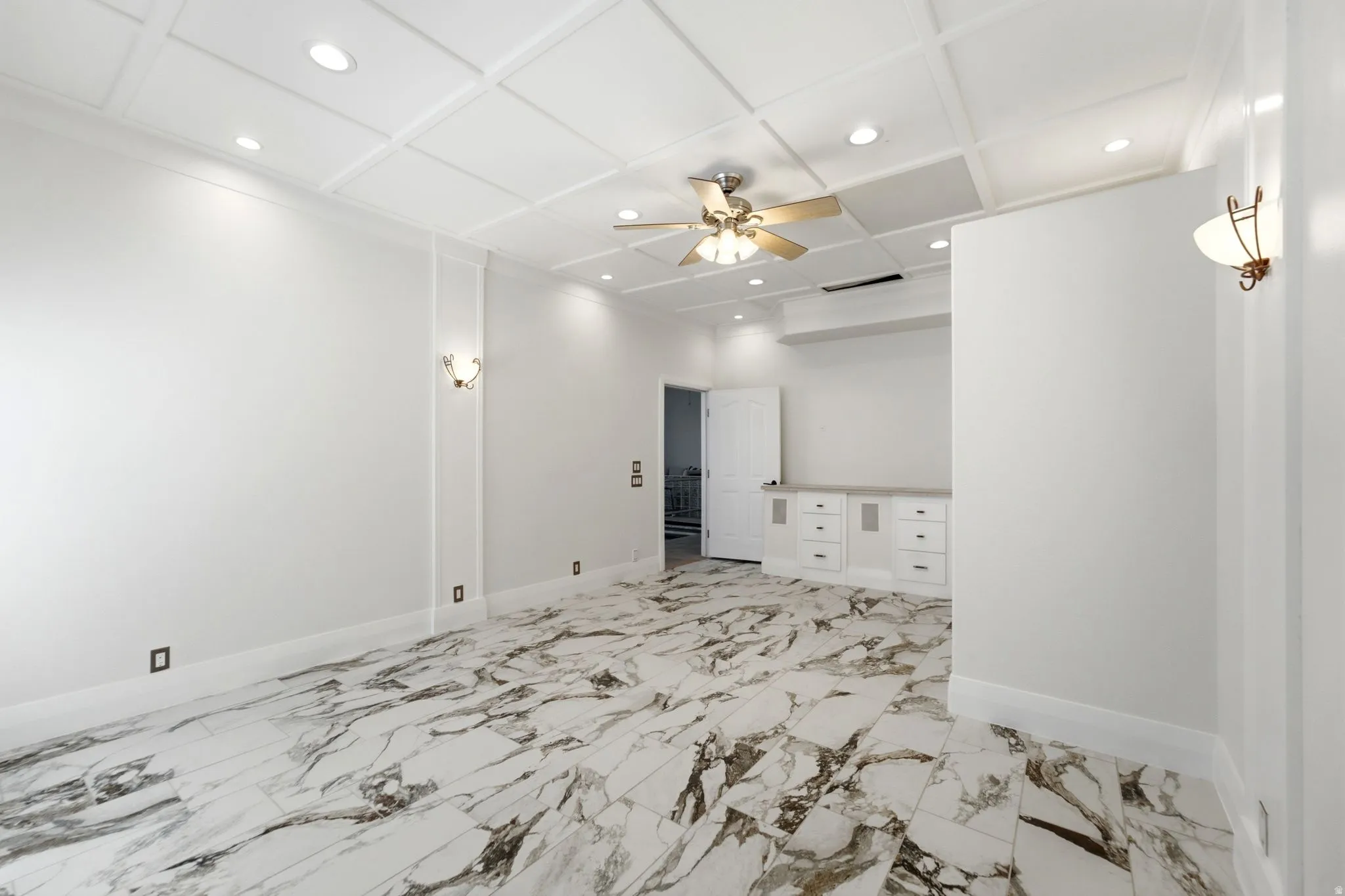 Coffered ceiling with recessed lighting and a ceiling fan