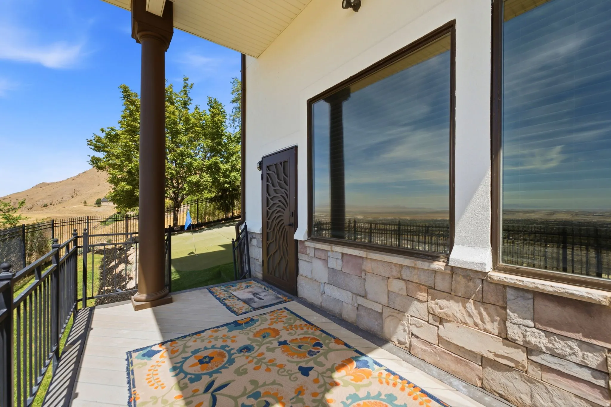 Covered outdoor patio with a stone facade