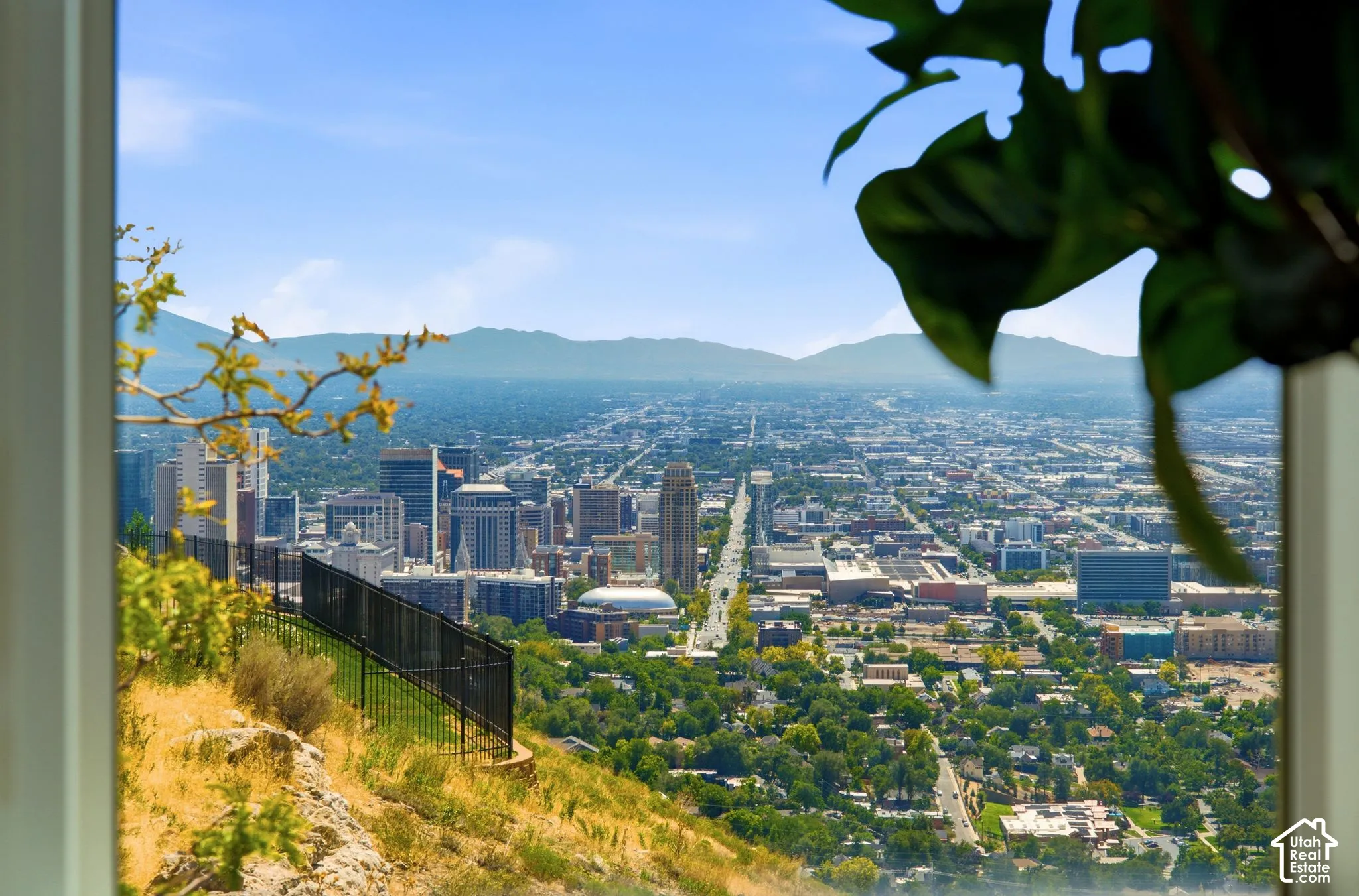 Expansive city skyline with distant mountains and a clear sky