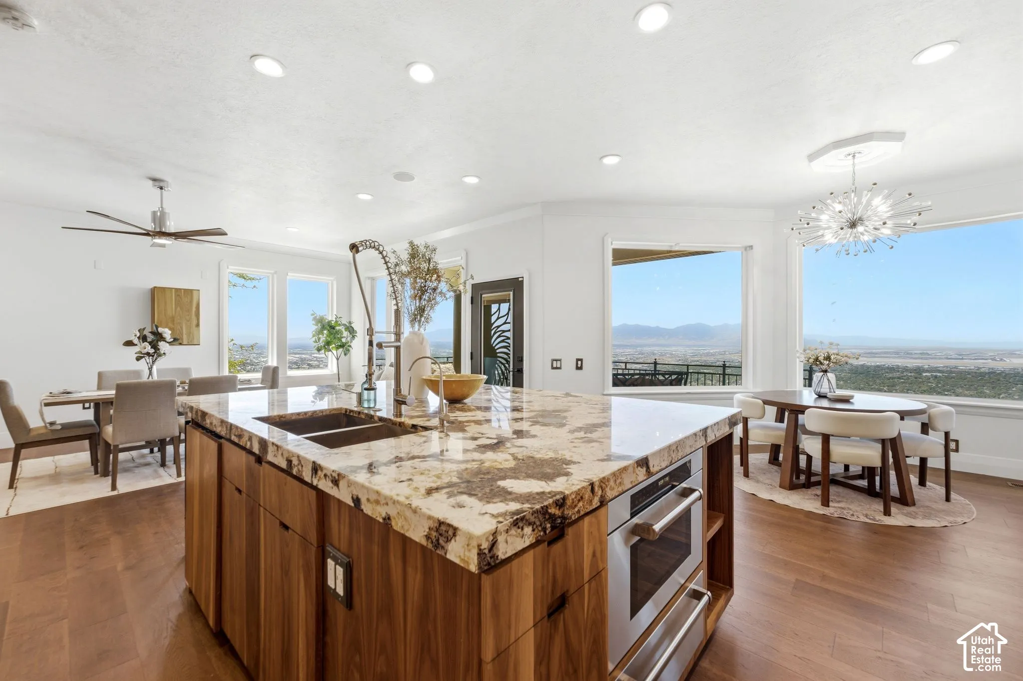 Expansive kitchen island with a stone countertop and integrated sink