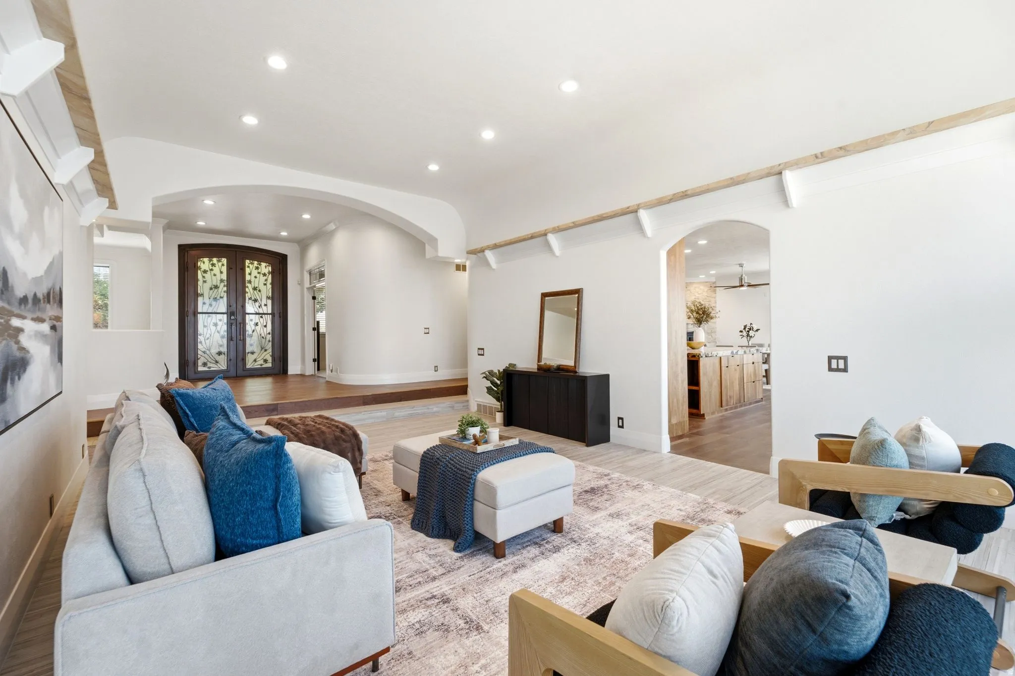 Arched entryways, recessed lighting, wood-finish flooring, and decorative wood ceiling beams