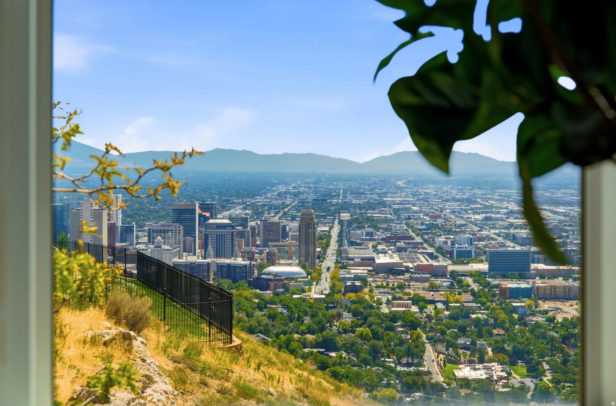 Expansive city skyline with distant mountains and a clear sky