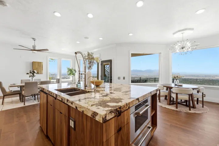 Expansive kitchen island with a stone countertop and integrated sink