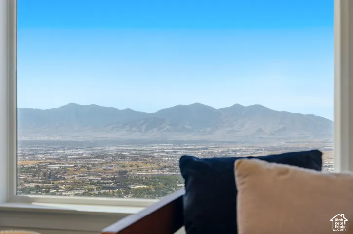 Panoramic city and mountain scenery framed by a large window