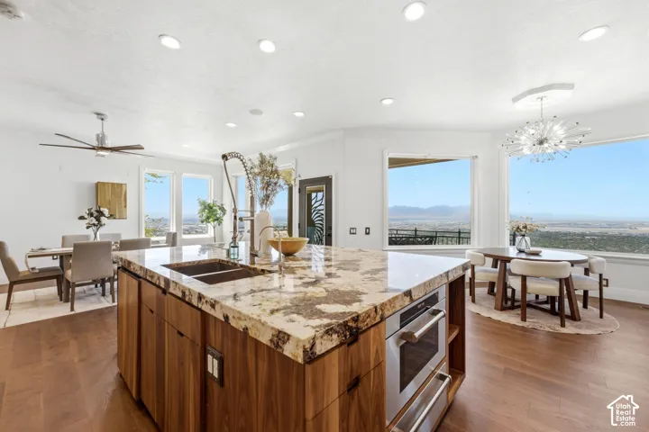 Expansive kitchen island with a stone countertop and integrated sink
