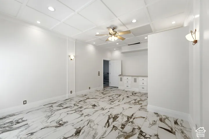 Coffered ceiling with recessed lighting and a ceiling fan