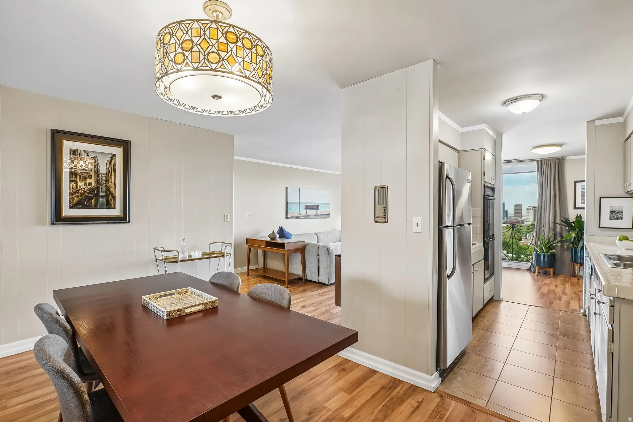 Wood-finish flooring throughout, with a tiled kitchen floor