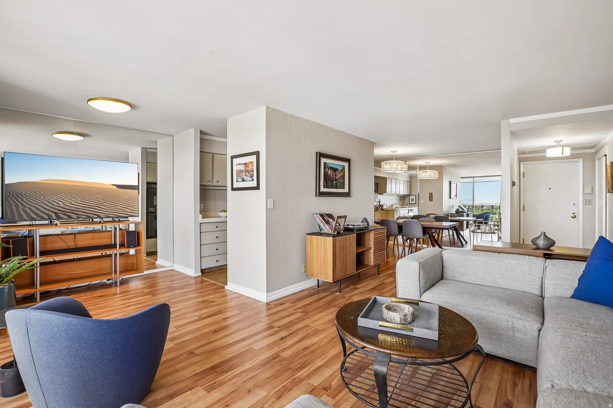 Wood-finish flooring throughout, with flush-mount and decorative pendant lighting