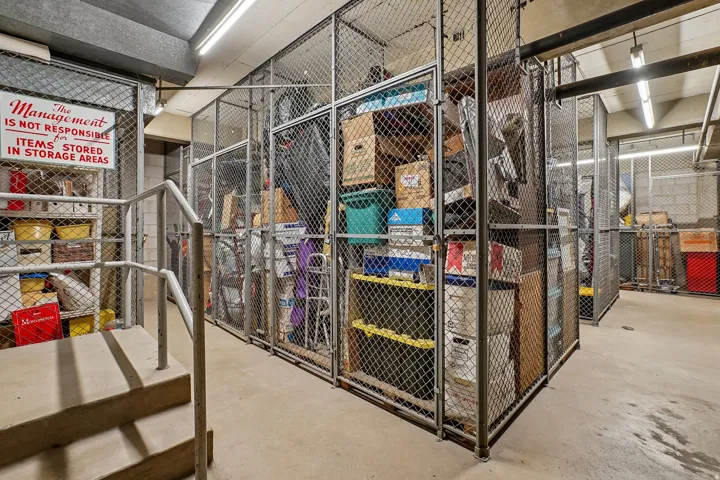Individual storage lockers with mesh metal construction and concrete flooring