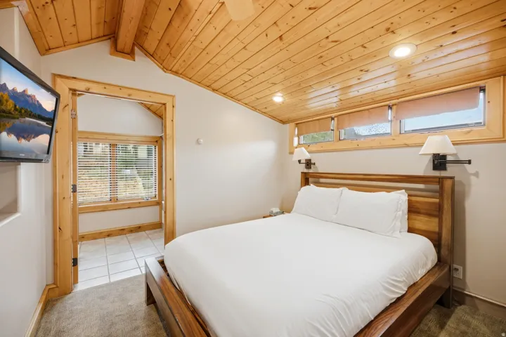 Wood-paneled vaulted ceiling with recessed lighting