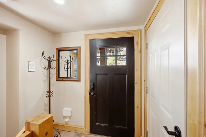 Recessed ceiling lighting, wood-finish flooring, and natural wood trim accents