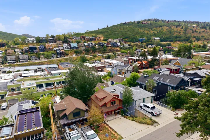 Hillsides with varied foliage surrounding residential and commercial structures