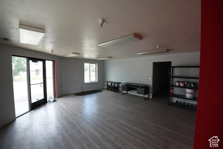 Wood-finish flooring, multiple windows, and recessed lighting fixtures
