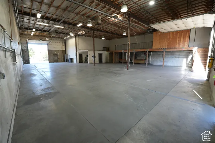 Expansive concrete flooring with an elevated wood-finish platform