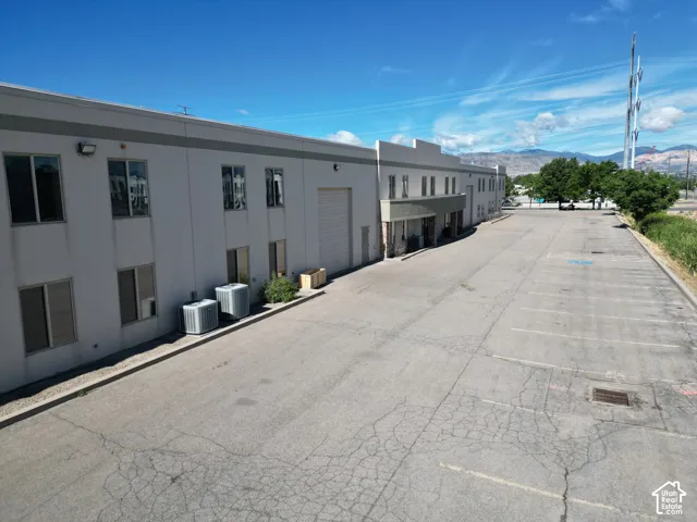 Two-story commercial building with multiple windows, a loading dock, and a covered entry