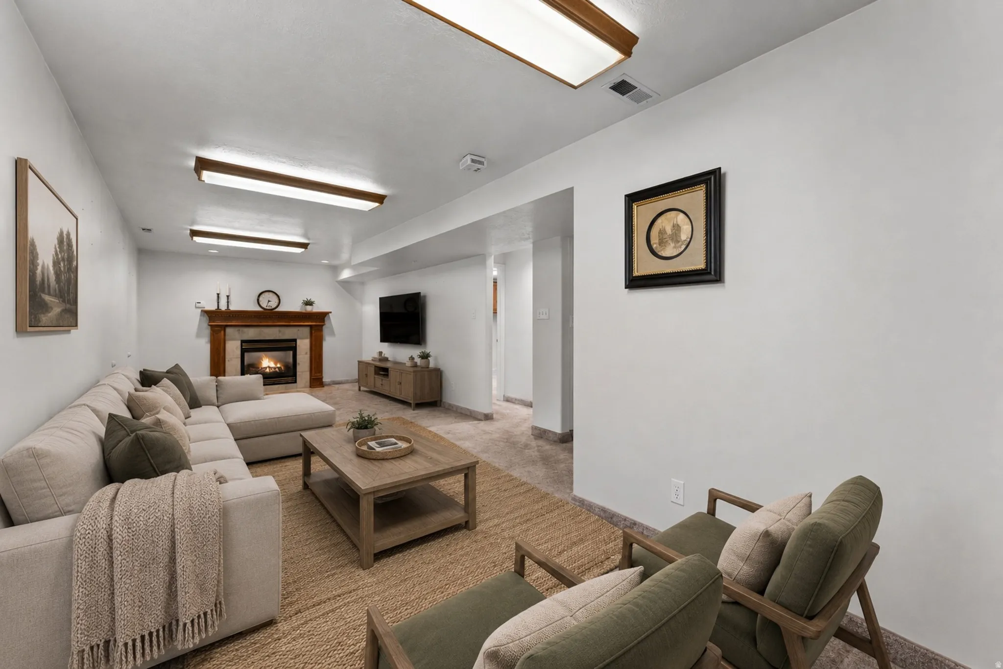 Recessed ceiling lighting, a fireplace with a wood mantel, light-toned wall finishes, and a tiled floor