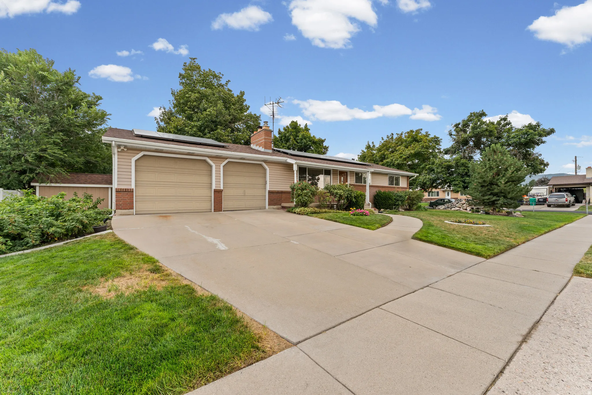 Two-car garage with overhead doors, brick accents, and siding exterior