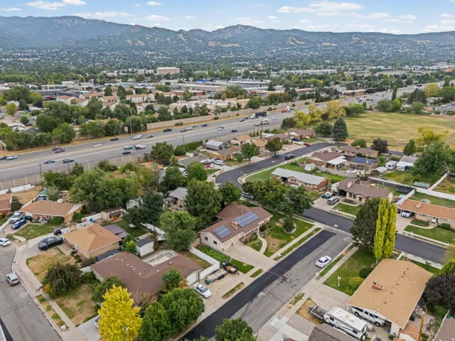 Residential area with established trees and mountain backdrop