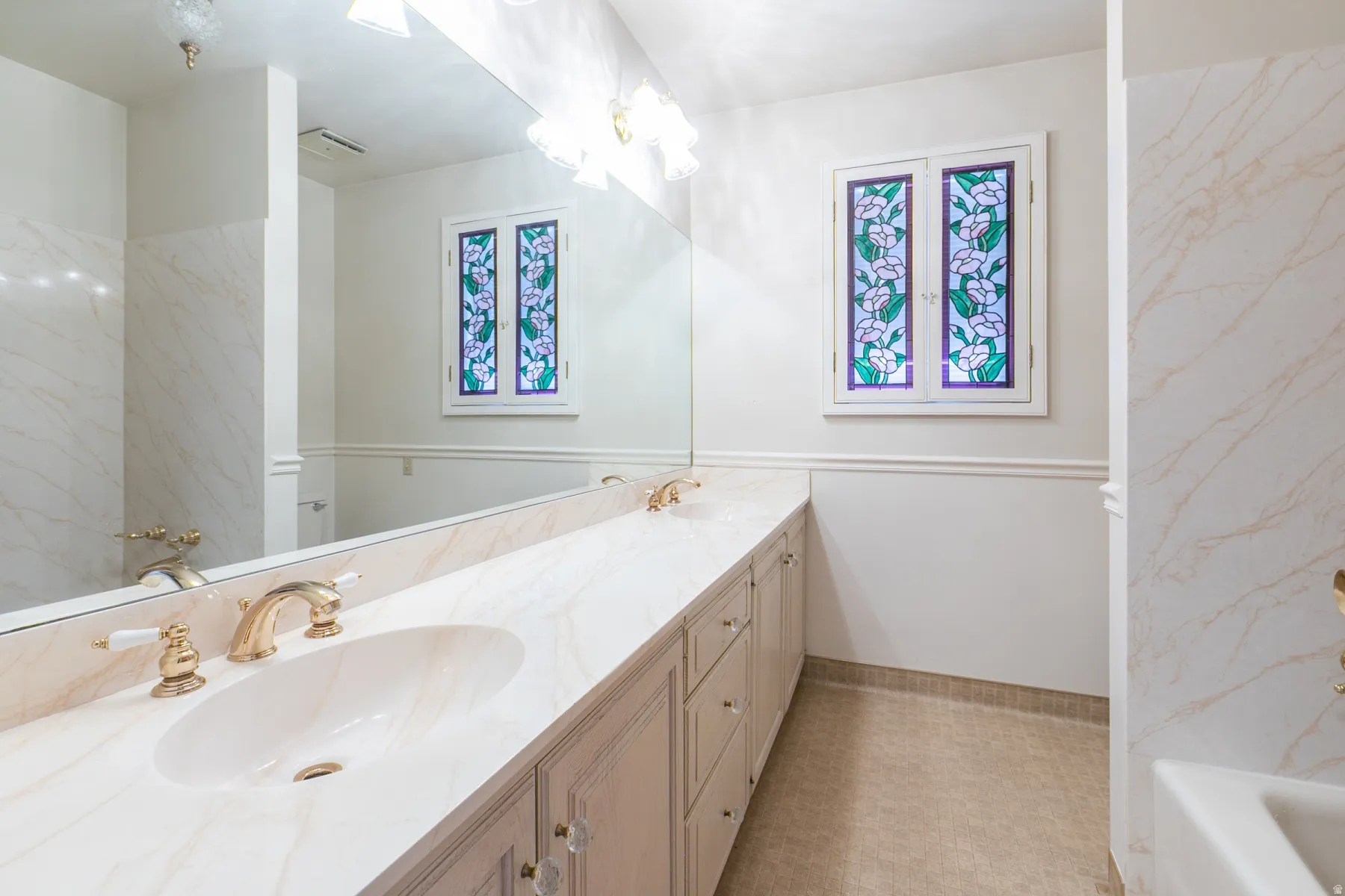 Dual vanity with integrated sinks and brass-finish fixtures