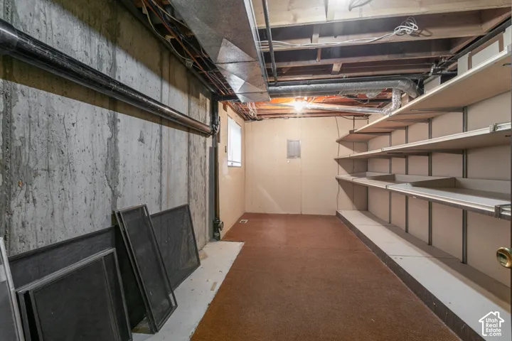 Expansive unfinished basement featuring concrete walls and exposed overhead joists