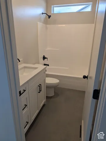 Bathroom featuring a white shaker-style vanity with a quartz countertop, matte black fixtures, grey tile flooring, and a shower-tub combination with an elongated clerestory window