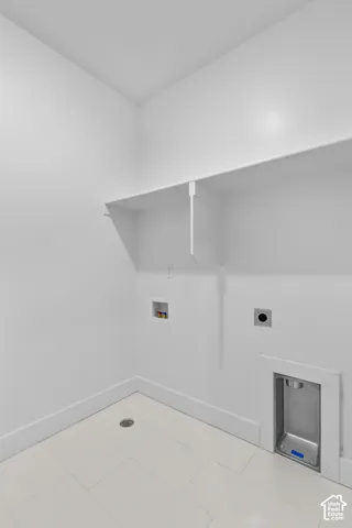 White walls with a utility shelf, tile flooring, and floor drain