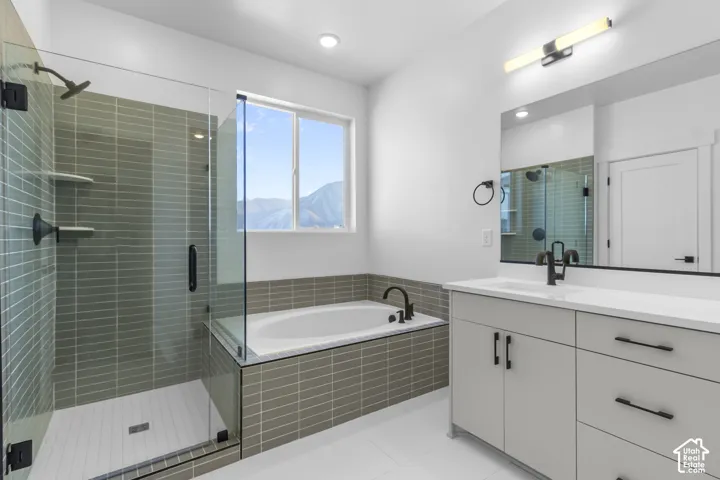 Contemporary bathroom featuring a glass-enclosed shower with subway tile, a built-in soaking tub, a single vanity with stone countertop, and matte black fixtures