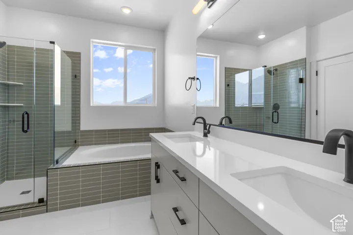 Dual vanity with integrated sinks, matte black fixtures, and a large mirror
