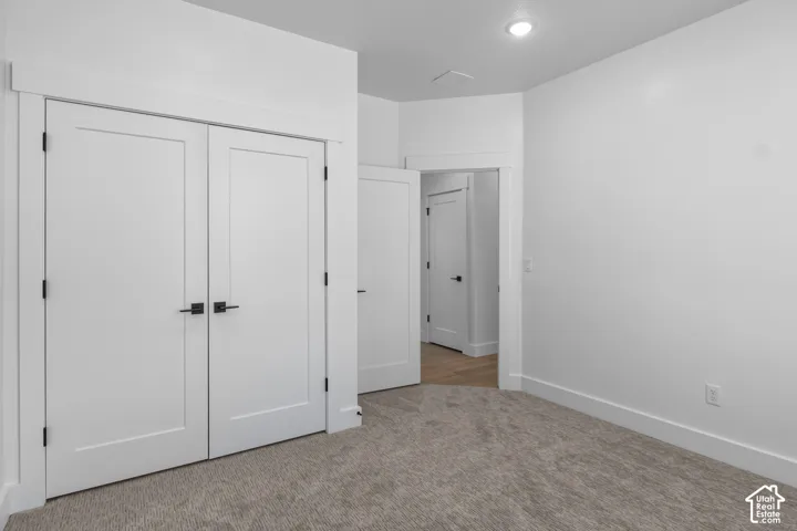 White walls, recessed lighting, and carpeted flooring