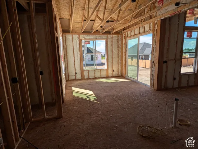 Unfinished interior framing with exposed ceiling joists and subfloor