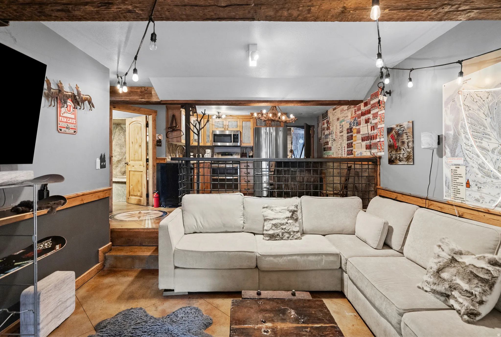 Exposed wood beams, concrete flooring, wood paneling, metal railing, and recessed lighting