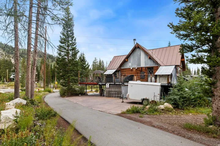 Wood siding and corrugated metal exterior with a brown metal roof