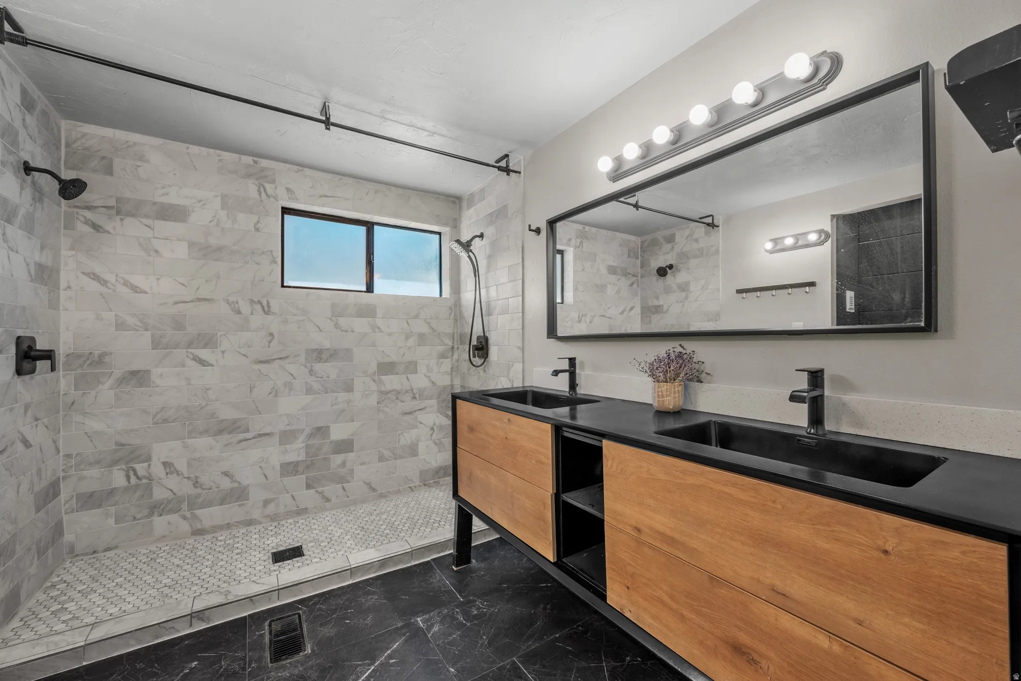 Dual vanity with black integrated sinks and matte black fixtures