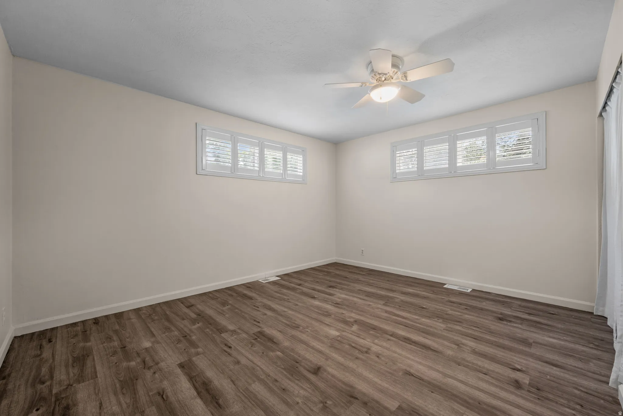 Wood-finish flooring with neutral wall tones and white trim