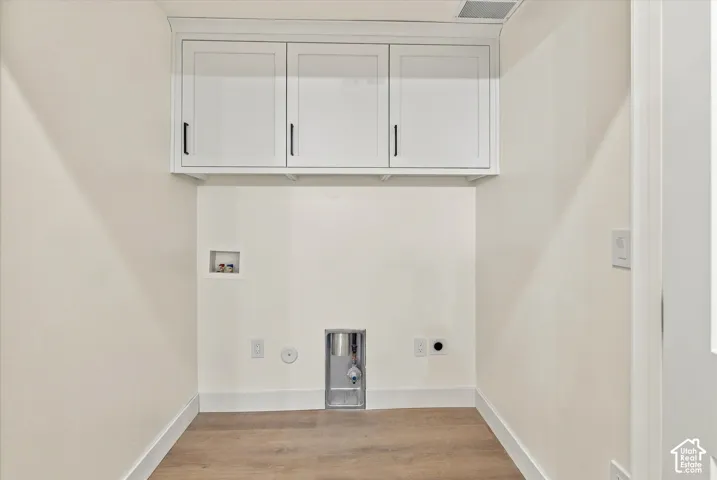 Light wood-finish flooring with white baseboards