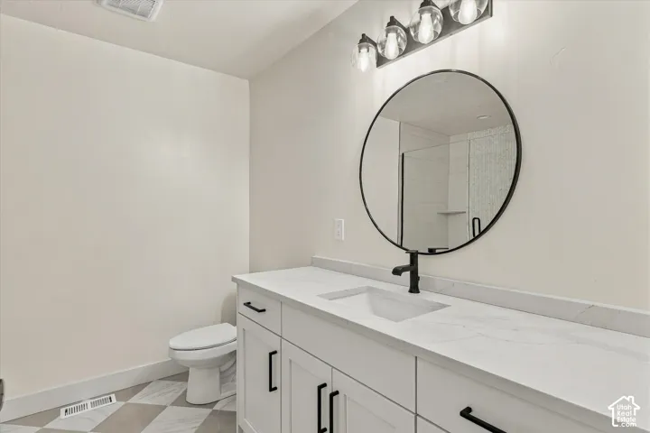 Dual vanity with white shaker-style cabinetry, white countertops, and integrated rectangular sinks