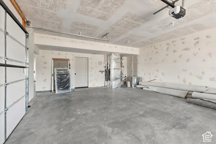 Concrete flooring with an overhead garage door and an automatic opener