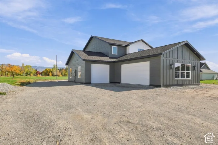 Contemporary exterior featuring gray horizontal siding and board-and-batten accents