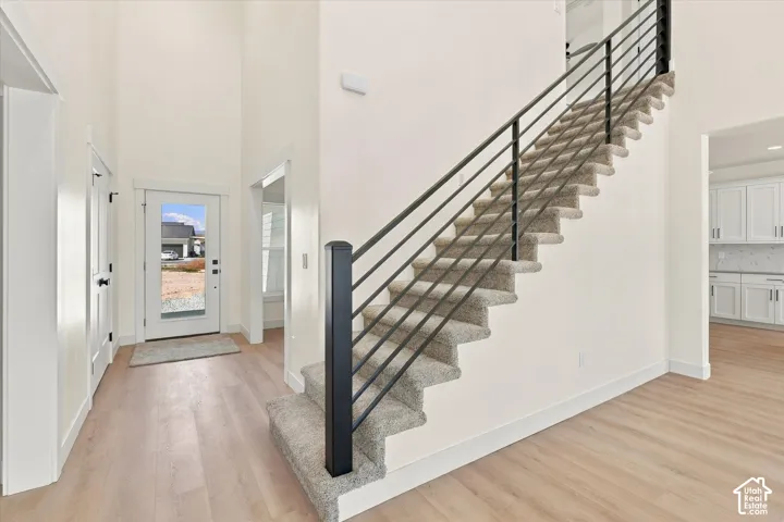 High ceilings and light wood-finish flooring