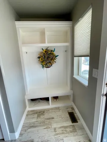Built-in storage bench with overhead shelving and individual compartments