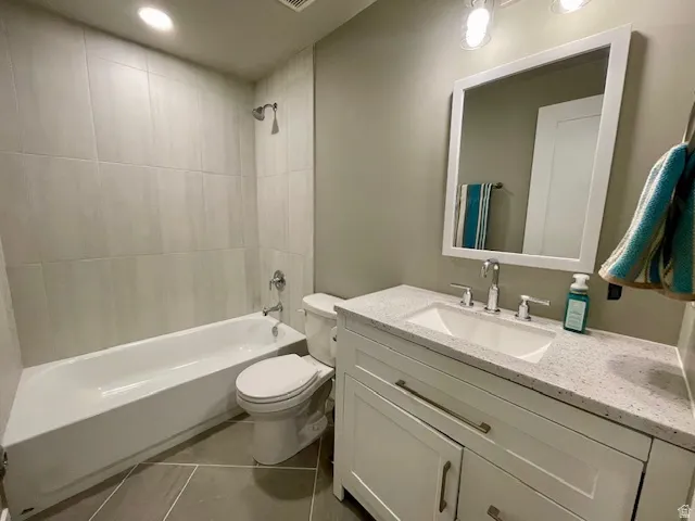 Downstairs full bathroom; White vanity with a speckled countertop and undermount sink