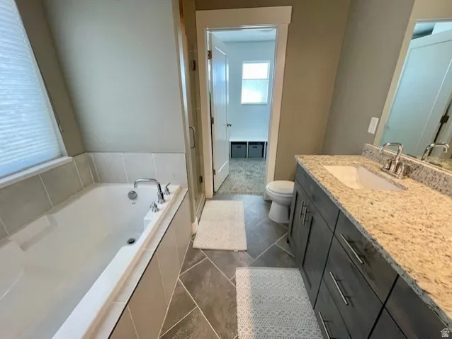 Primary bathroom; Built-in soaking tub with tile surround.  This bathroom has a large tile shower as well!