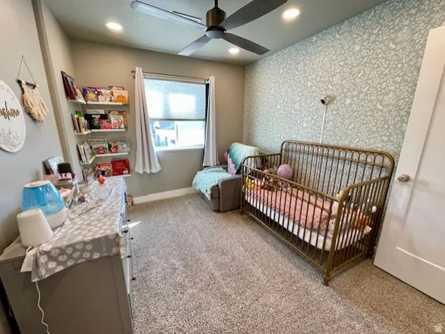 Bedroom # 2; Recessed lighting, ceiling fan, plush carpet, built-in shelving, and accent wall