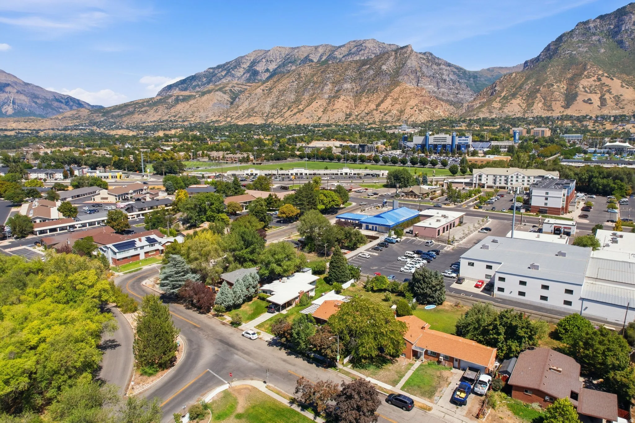Mountain backdrop with a developed community featuring residential structures and commercial buildings