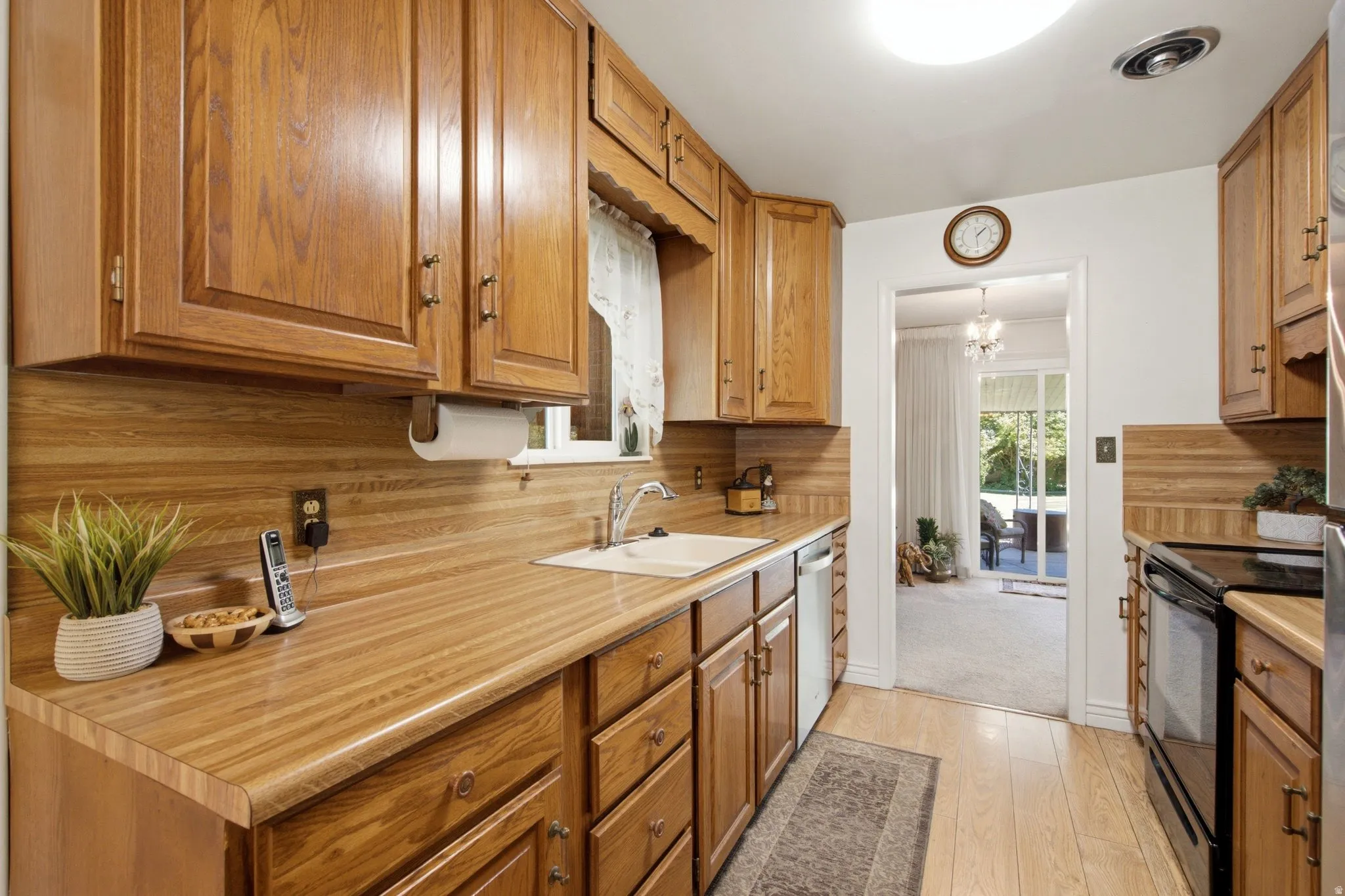 Galley kitchen featuring wood-finish cabinetry, wood-finish countertops, and wood-finish flooring
