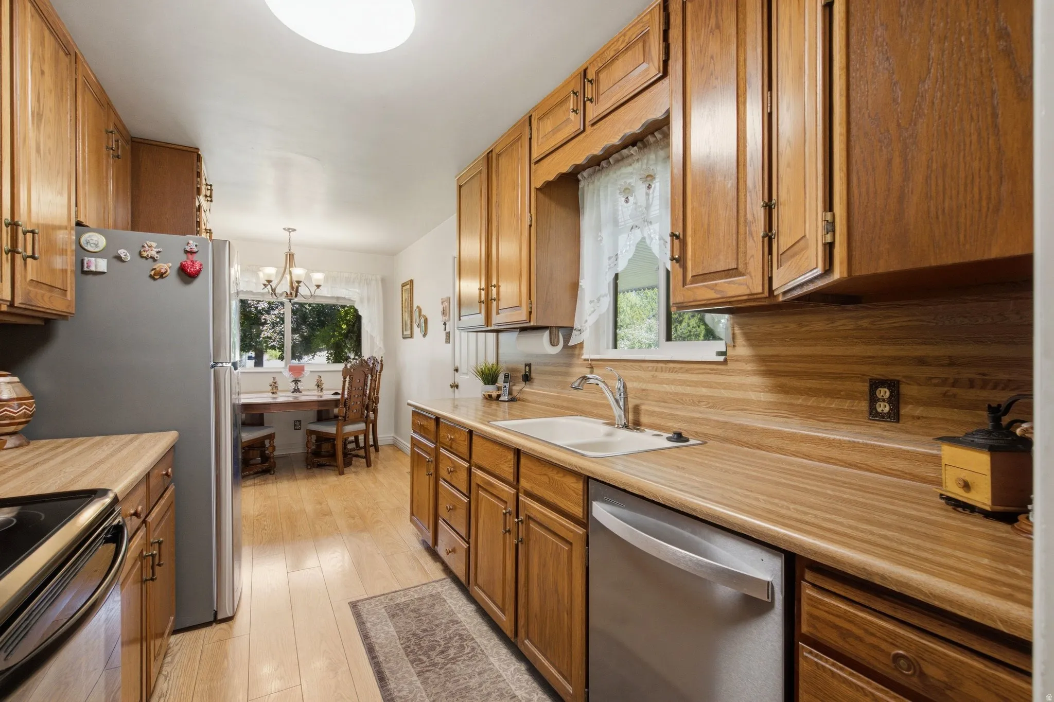 Kitchen featuring wood-finish cabinetry, light wood-finish countertops, and stainless steel appliances