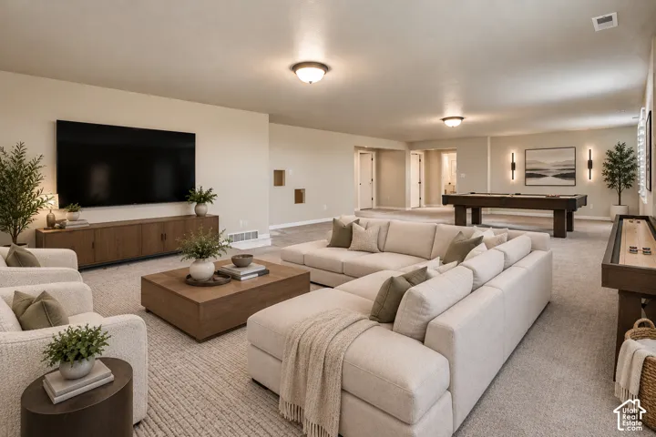 Virtually Staged: Spacious recreation room featuring recessed wall niches, a built-in media console, and ceiling-mounted light fixtures